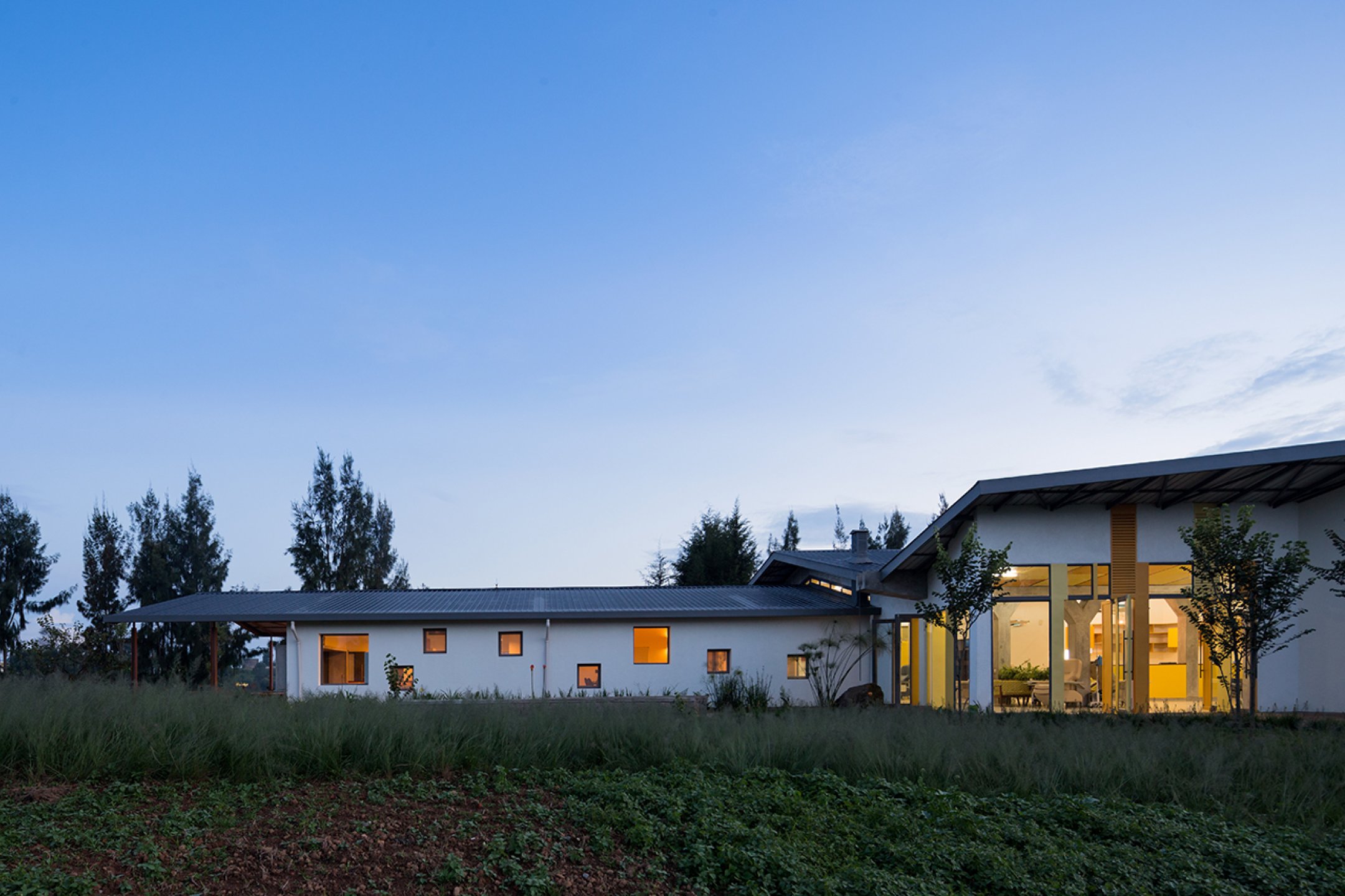 Photo of Butaro Ambulatory Cancer Center, Photo by Iwan Baan, Totality of the Building Exterior Nighttime View