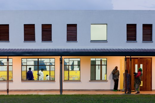 Photo of Butaro District Hospital, Photo by Iwan Baan, Nightitme View of Exterior Hallway with View into Hospital Rooms 