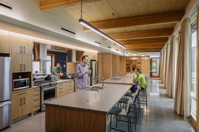 The kitchen within the LIFTT building. Equitable and flexible use is a theme throughout the facility: the centralized kitchen, laundry, and social areas include multiple appliance options, work surfaces heights, and seating configurations.
