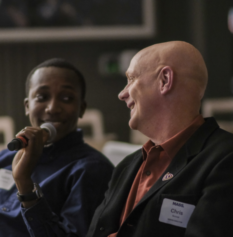 Chris Scovel smiles at person holding microphone.