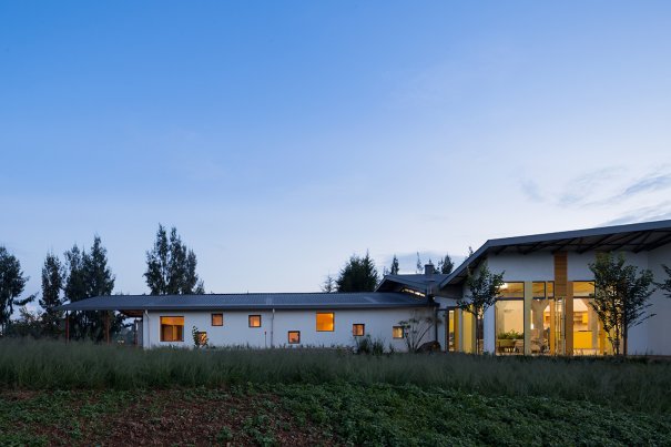 Photo of Butaro Ambulatory Cancer Center, Photo by Iwan Baan, Totality of the Building Exterior Nighttime View