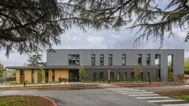 The Washington State School for the Blind’s Life Skills Training Center, viewed from the outside across the street. The exterior materials balance residential character with durability and sustainability, and the scaling and stepping of building volumes creates opportunities for passive window shading and covered outdoor porches, contributing to a welcoming presence from the street.
